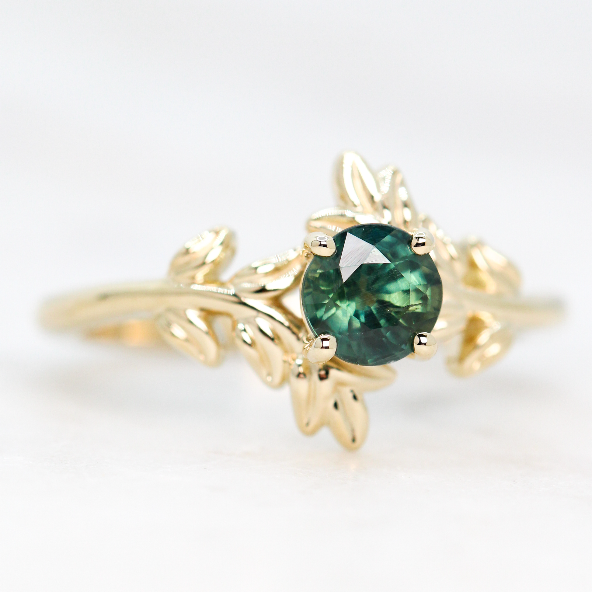 Sara Ring with a 0.94 Carat Round Teal Green Sapphire in 14k Yellow Gold - Ready to Size and Ship - Midwinter Co. Alternative Bridal Rings and Modern Fine Jewelry