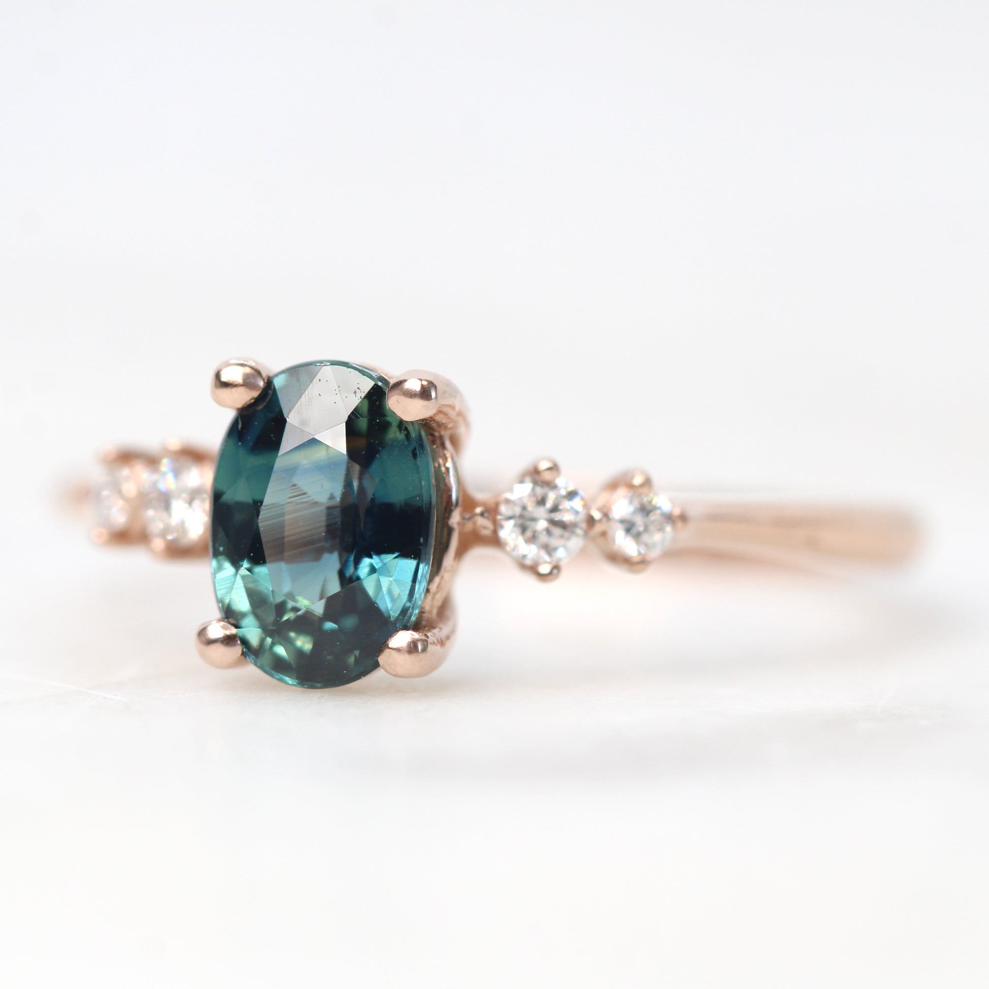 Cordelia Ring with a 1.17 Carat Oval Light Teal Blue Sapphire and White Accent Diamonds in 10k Rose Gold - Ready to Size and Ship - Midwinter Co. Alternative Bridal Rings and Modern Fine Jewelry