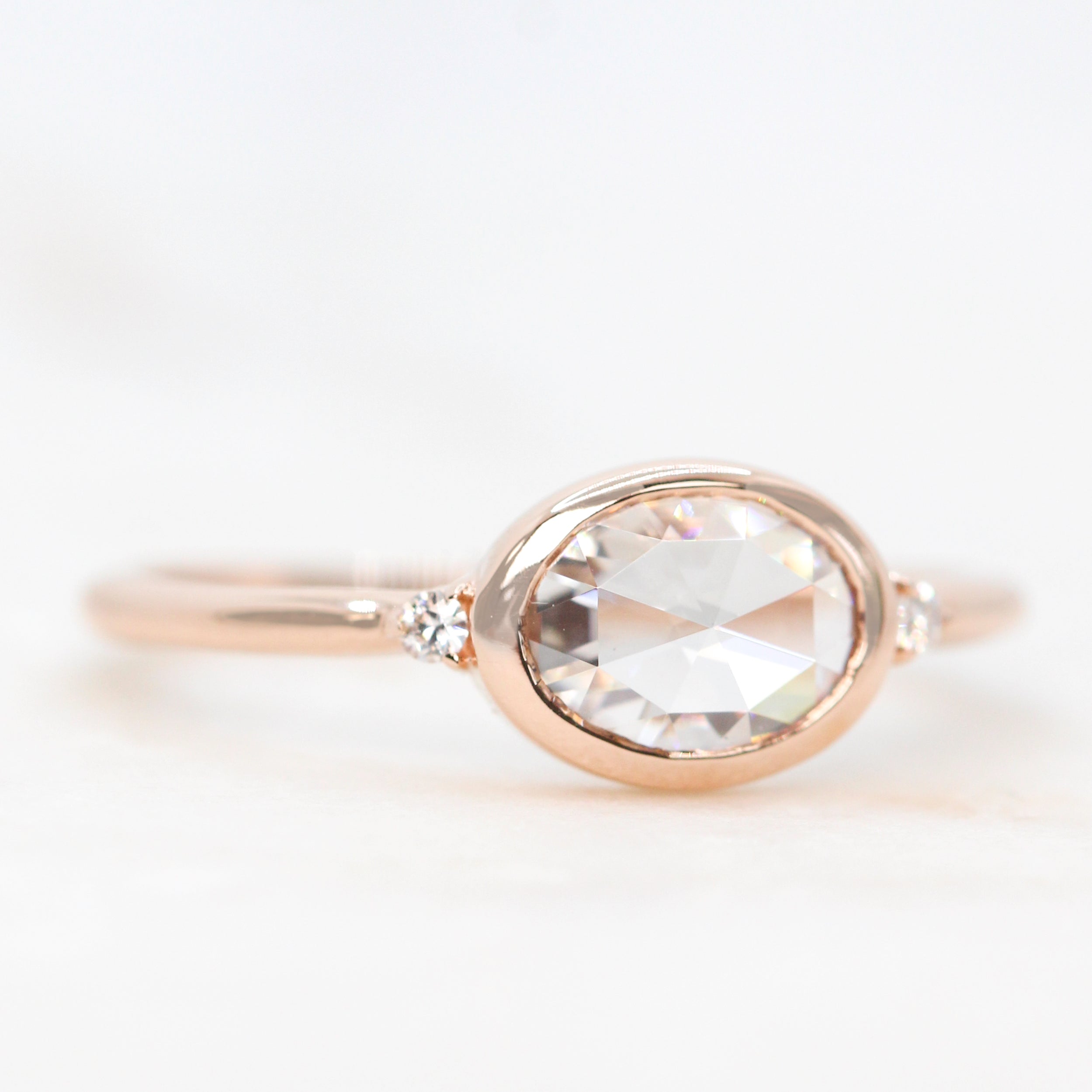 Beatrice Ring with a 0.66 Carat Clear Oval Moissanite and Round