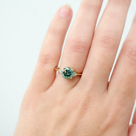 Imogene Ring with a 1.50 Carat Round Teal Moissanite and White Accent Diamonds in 14k Yellow Gold - Ready to Size and Ship