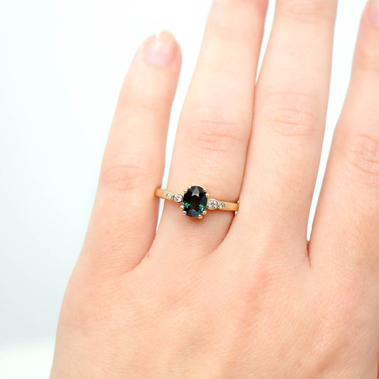 Joyce Ring with a 1.21 Carat Oval Teal Sapphire and White Diamond Accents in 14k Yellow Gold - Ready to Size and Ship