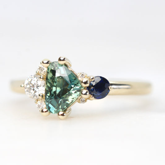 Project: Custom Serena Ring with a 1 Carat Teal Blue Trillion Sapphire and Asymmetrical Accent Diamonds in 14k