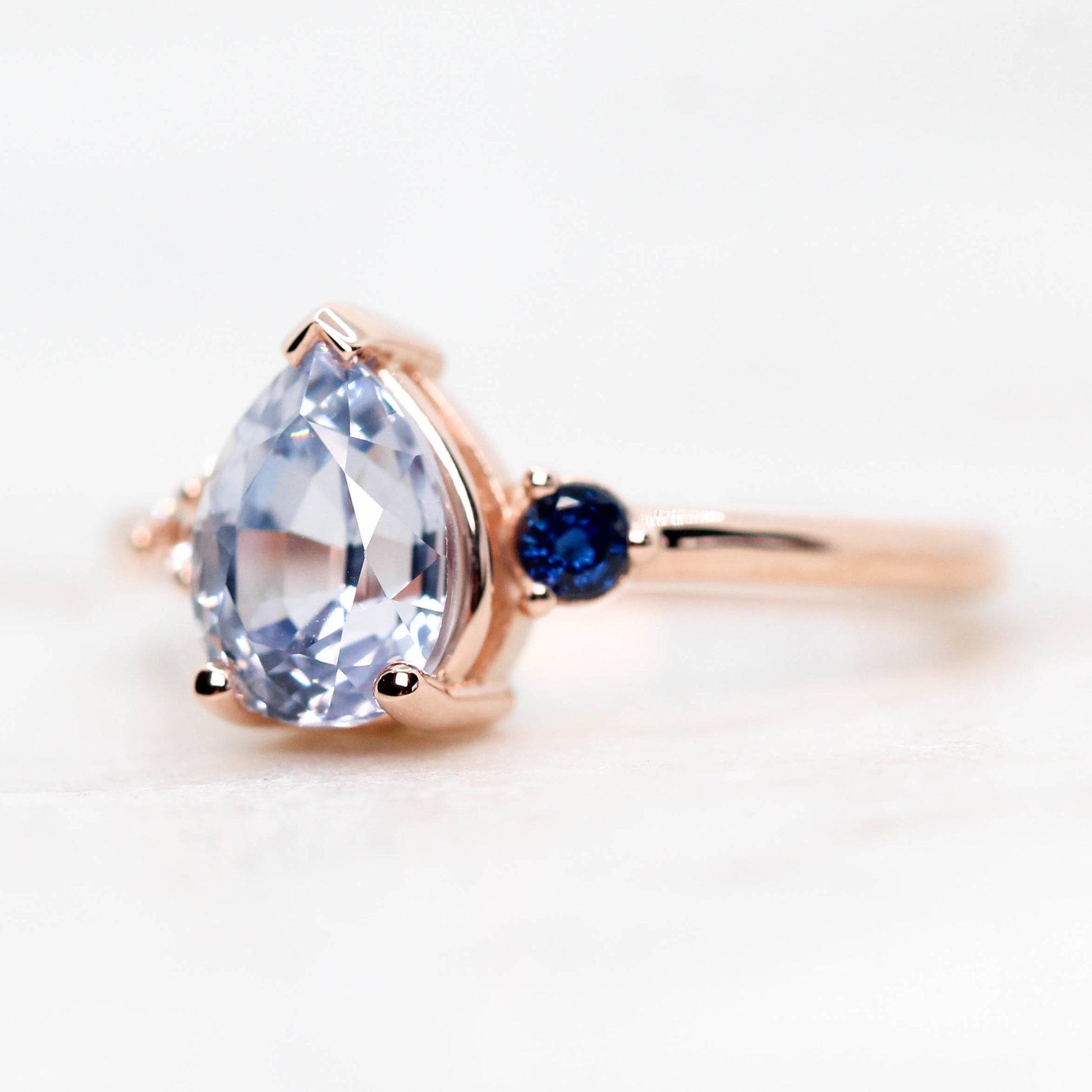 Fletcher Ring with a 1.87 Carat Blue Pear Sapphire and Accent Sapphires in 14k Rose Gold - Ready to Size and Ship - Midwinter Co. Alternative Bridal Rings and Modern Fine Jewelry