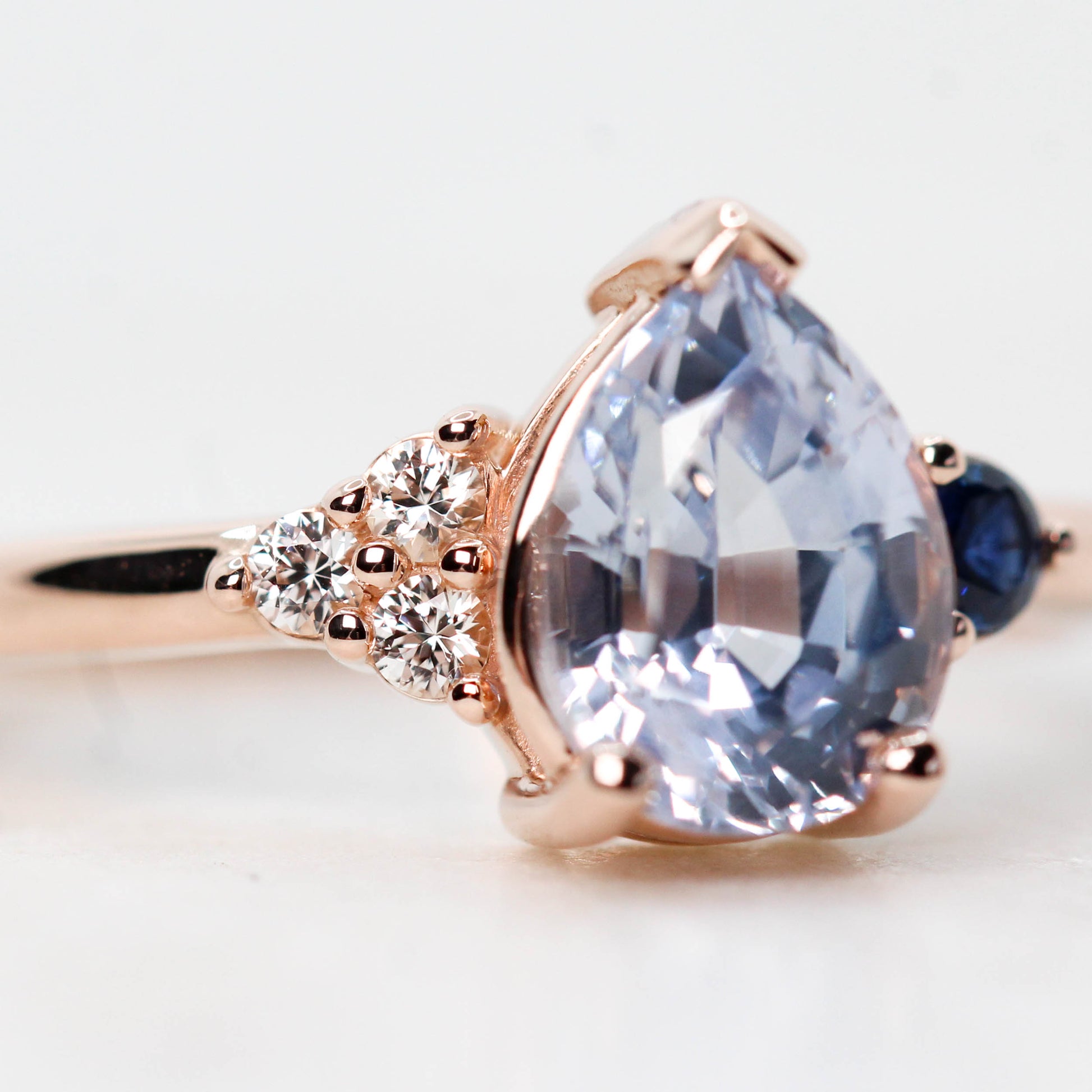 Fletcher Ring with a 1.87 Carat Blue Pear Sapphire and Accent Sapphires in 14k Rose Gold - Ready to Size and Ship - Midwinter Co. Alternative Bridal Rings and Modern Fine Jewelry