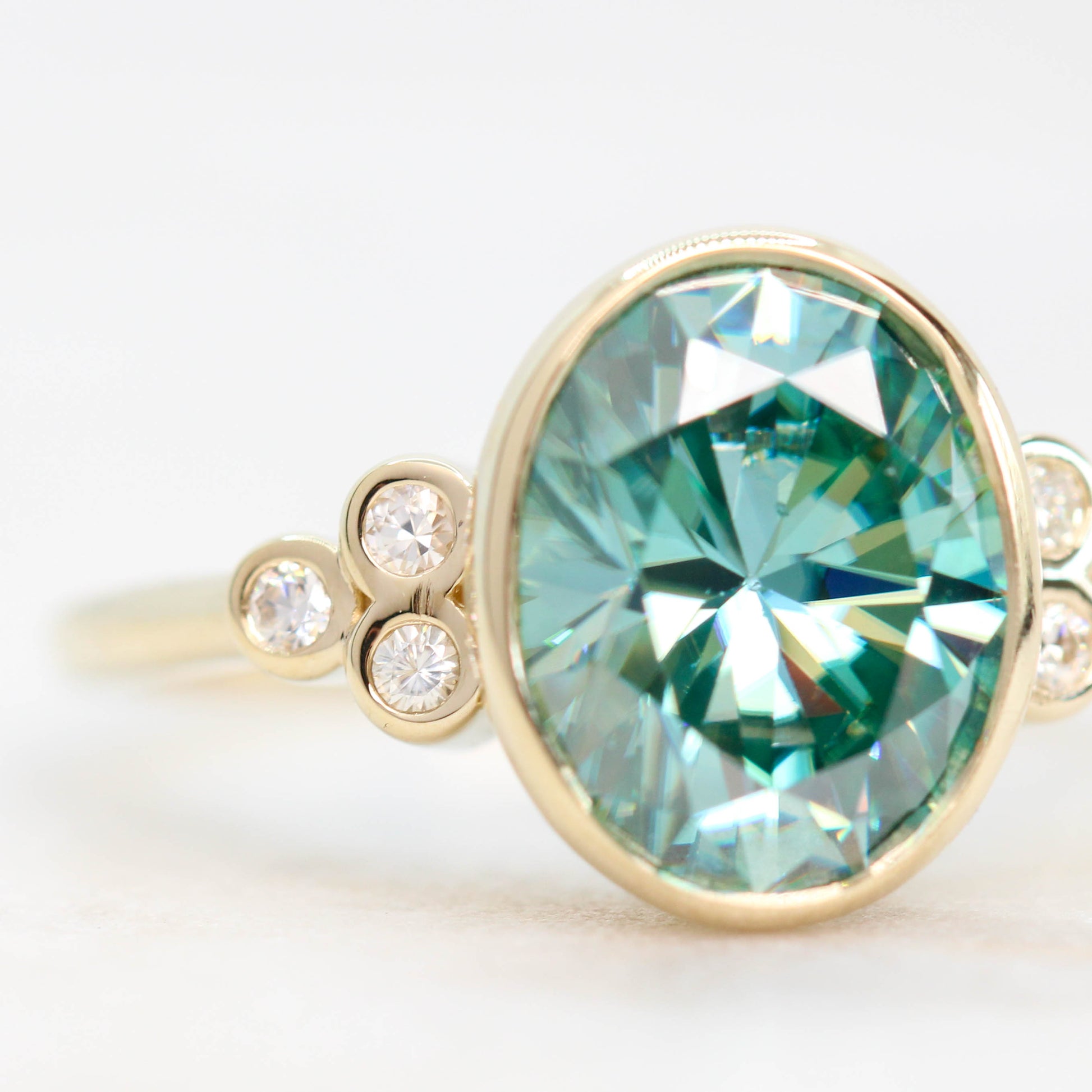 Sophia Ring with a 2.40 Carat Teal Oval Moissanite and Accent Diamonds in 14k Yellow Gold - Ready to Size and Ship - Midwinter Co. Alternative Bridal Rings and Modern Fine Jewelry