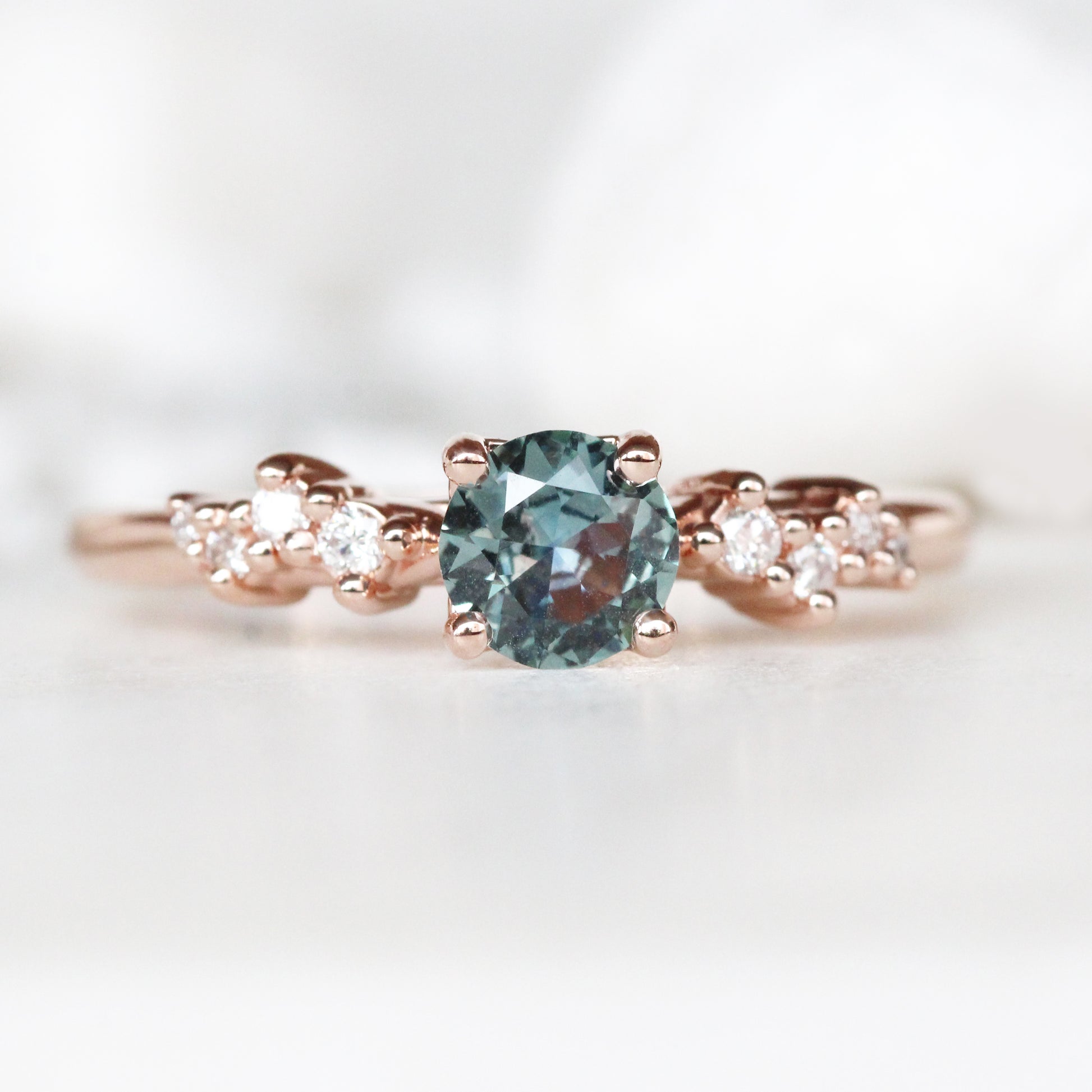 Zealan Ring with a 0.63 Carat Round Teal Sapphire and White Accent Diamonds in 10K Rose Gold - Ready to Size and Ship - Midwinter Co. Alternative Bridal Rings and Modern Fine Jewelry