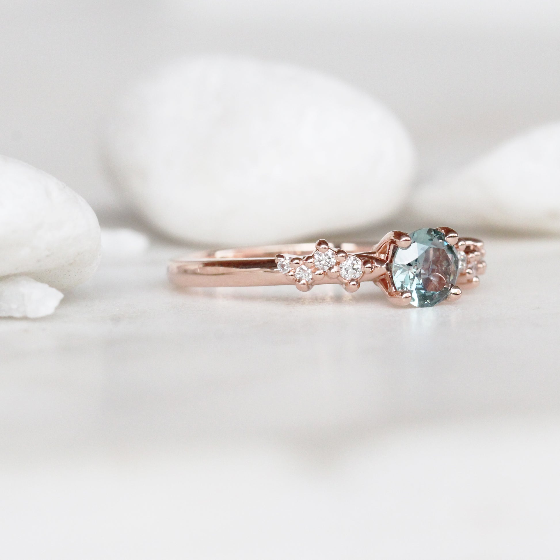 Zealan Ring with a 0.63 Carat Round Teal Sapphire and White Accent Diamonds in 10K Rose Gold - Ready to Size and Ship - Midwinter Co. Alternative Bridal Rings and Modern Fine Jewelry