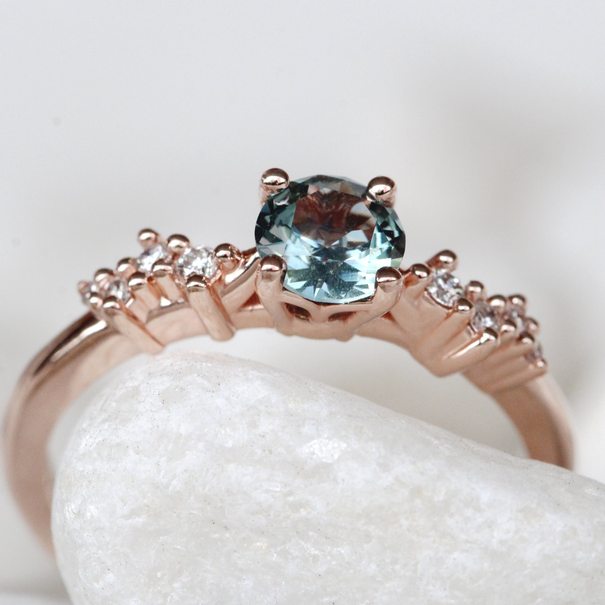 Zealan Ring with a 0.63 Carat Round Teal Sapphire and White Accent Diamonds in 10K Rose Gold - Ready to Size and Ship - Midwinter Co. Alternative Bridal Rings and Modern Fine Jewelry