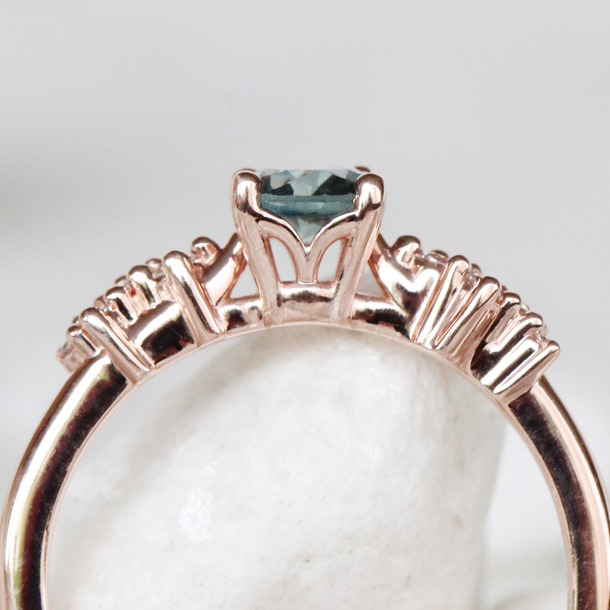 Zealan Ring with a 0.63 Carat Round Teal Sapphire and White Accent Diamonds in 10K Rose Gold - Ready to Size and Ship - Midwinter Co. Alternative Bridal Rings and Modern Fine Jewelry