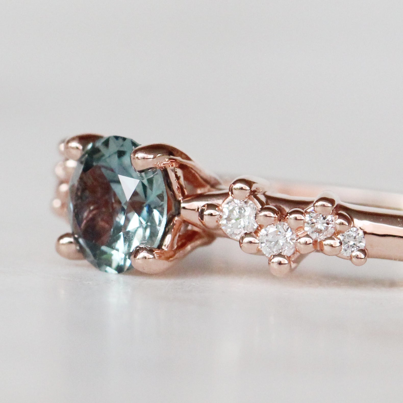 Zealan Ring with a 0.63 Carat Round Teal Sapphire and White Accent Diamonds in 10K Rose Gold - Ready to Size and Ship - Midwinter Co. Alternative Bridal Rings and Modern Fine Jewelry