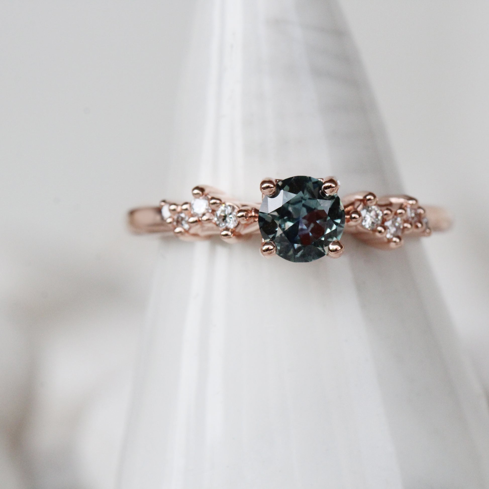 Zealan Ring with a 0.63 Carat Round Teal Sapphire and White Accent Diamonds in 10K Rose Gold - Ready to Size and Ship - Midwinter Co. Alternative Bridal Rings and Modern Fine Jewelry