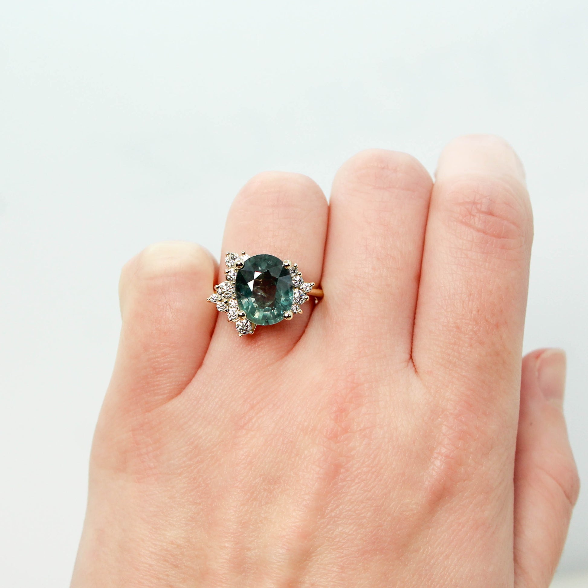 Orion Ring with a 6.00 Carat Teal Blue Oval Sapphire and White Accent Diamonds in 14k Yellow Gold - Ready to Size and Ship - Midwinter Co. Alternative Bridal Rings and Modern Fine Jewelry