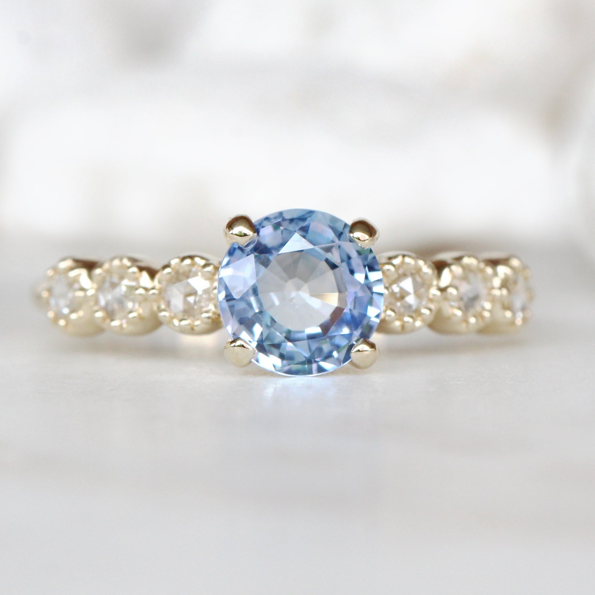 Rudy Ring with a 1.48 Carat Round Light Blue Sapphire and White Rose Cut Diamond Accents in 14K Yellow Gold - Ready to Size and Ship - Midwinter Co. Alternative Bridal Rings and Modern Fine Jewelry