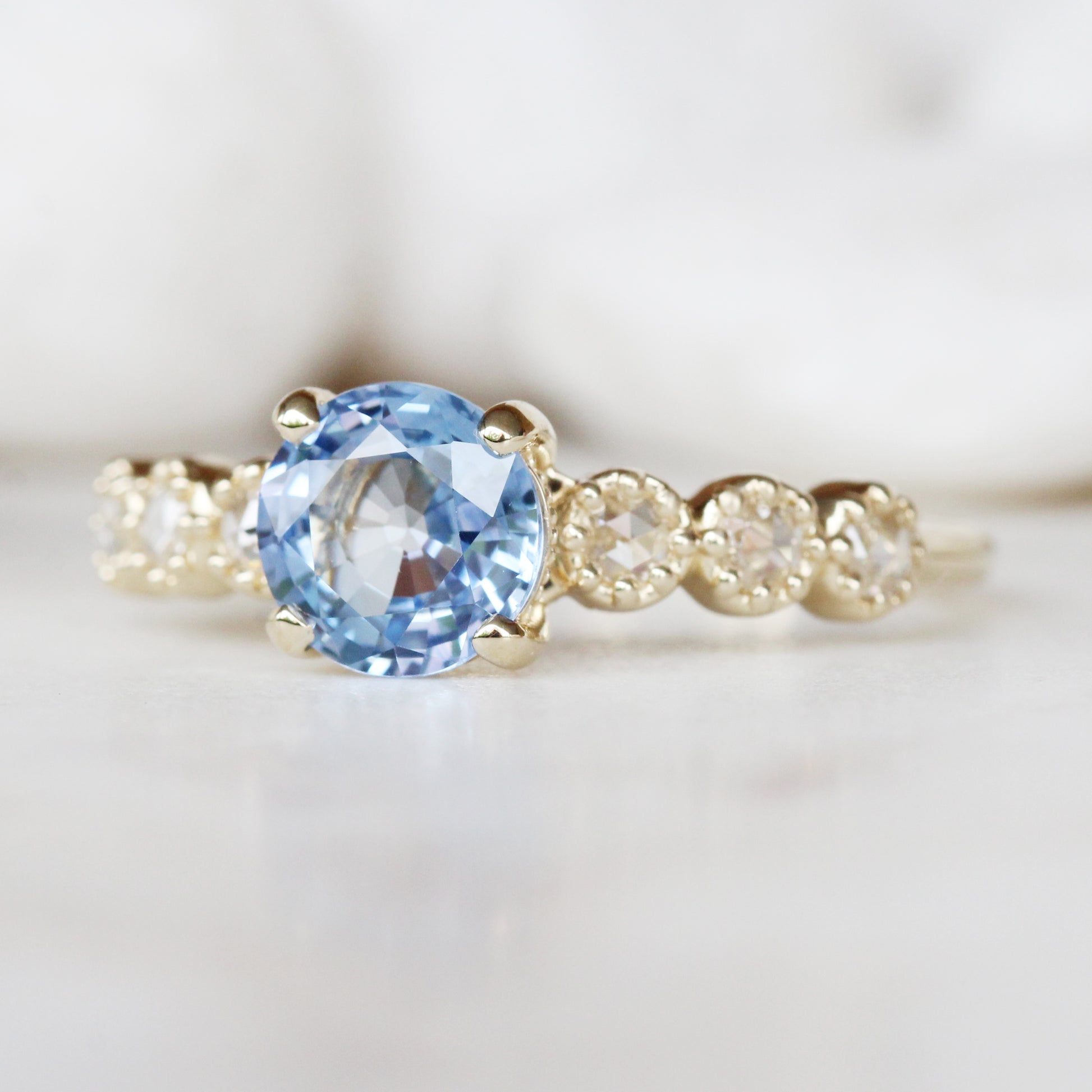 Rudy Ring with a 1.48 Carat Round Light Blue Sapphire and White Rose Cut Diamond Accents in 14K Yellow Gold - Ready to Size and Ship - Midwinter Co. Alternative Bridal Rings and Modern Fine Jewelry