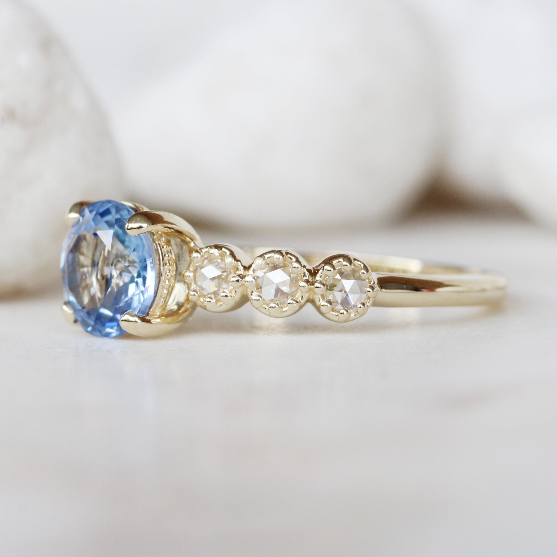 Rudy Ring with a 1.48 Carat Round Light Blue Sapphire and White Rose Cut Diamond Accents in 14K Yellow Gold - Ready to Size and Ship - Midwinter Co. Alternative Bridal Rings and Modern Fine Jewelry