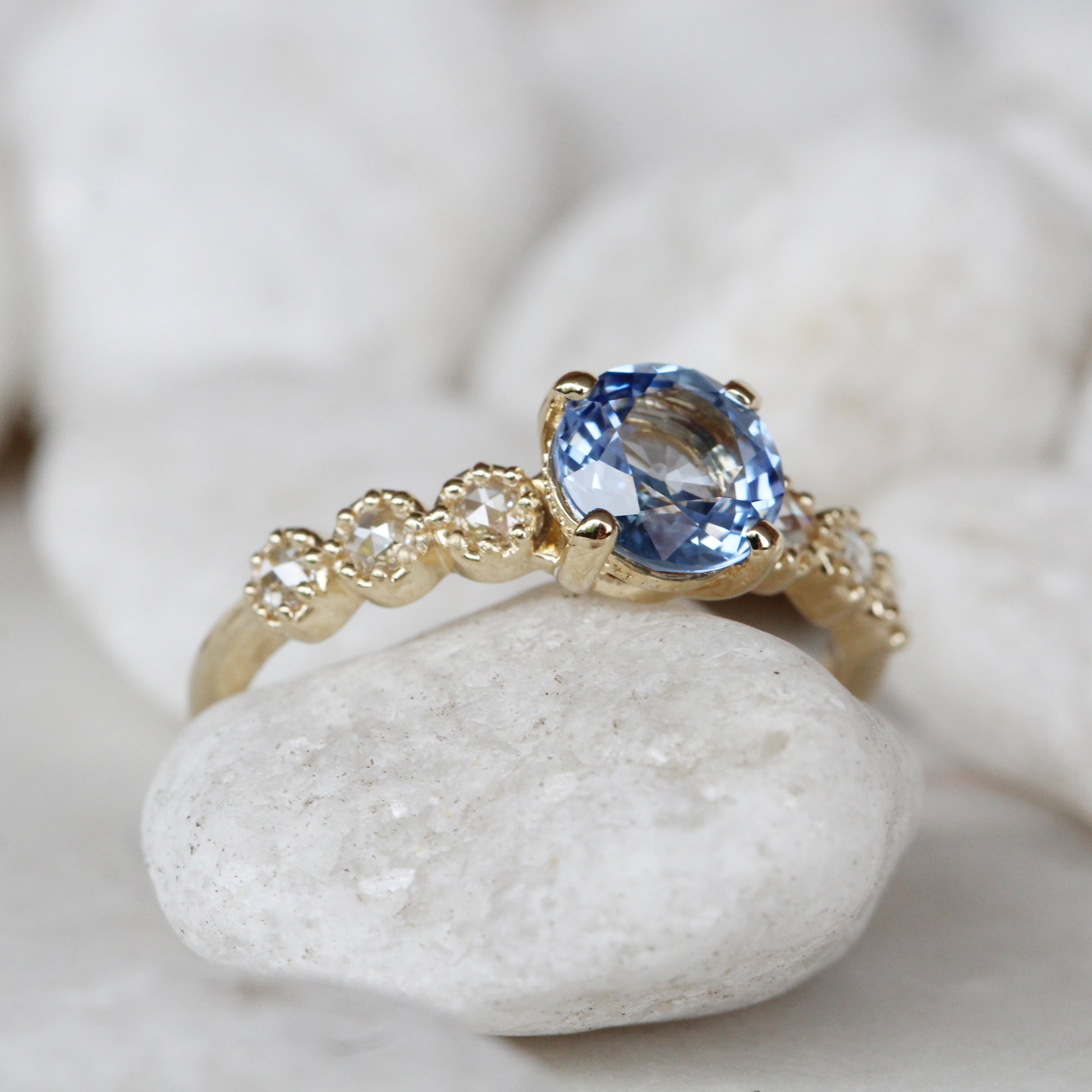 Rudy Ring with a 1.48 Carat Round Light Blue Sapphire and White Rose Cut Diamond Accents in 14K Yellow Gold - Ready to Size and Ship - Midwinter Co. Alternative Bridal Rings and Modern Fine Jewelry