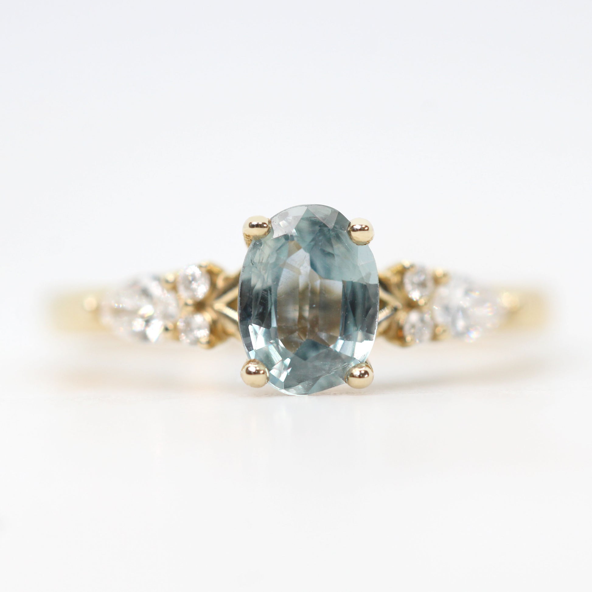 Jenna Ring with a 0.93 Carat Light Blue Oval Sapphire and White Accent Diamonds in 14k Yellow Gold - Ready to Size and Ship - Midwinter Co. Alternative Bridal Rings and Modern Fine Jewelry