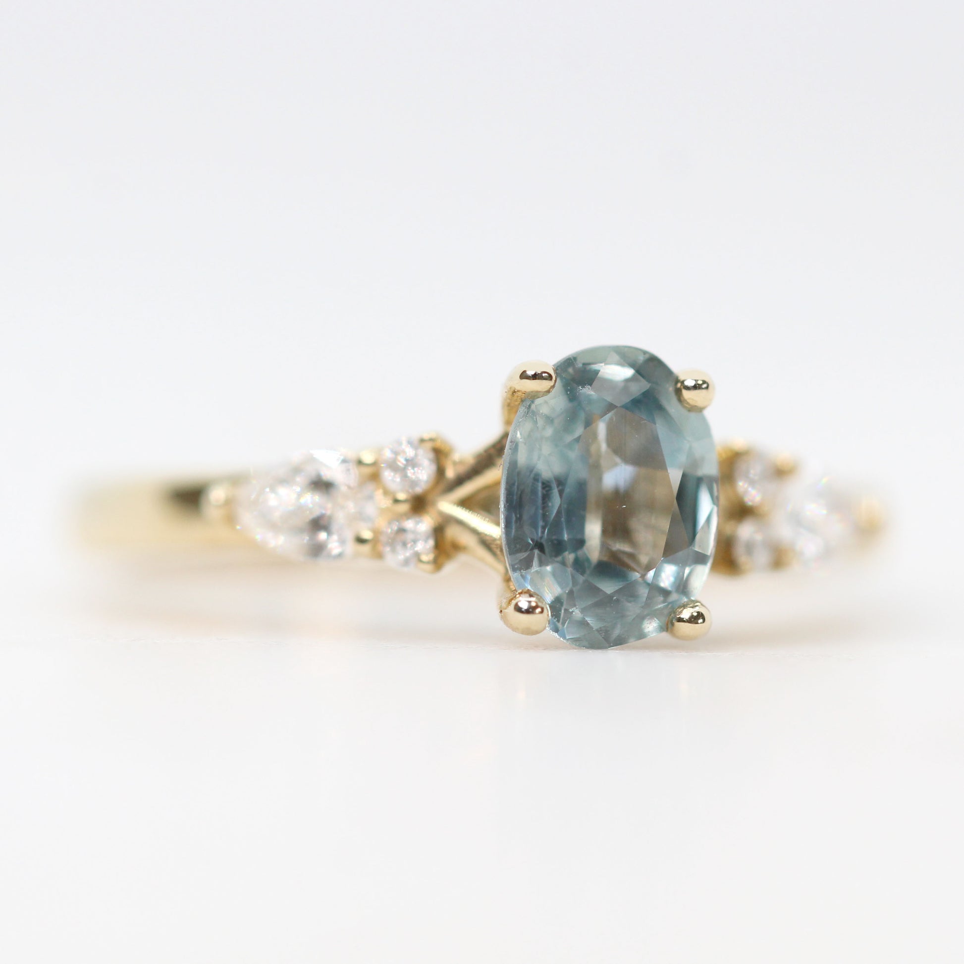 Jenna Ring with a 0.93 Carat Light Blue Oval Sapphire and White Accent Diamonds in 14k Yellow Gold - Ready to Size and Ship - Midwinter Co. Alternative Bridal Rings and Modern Fine Jewelry