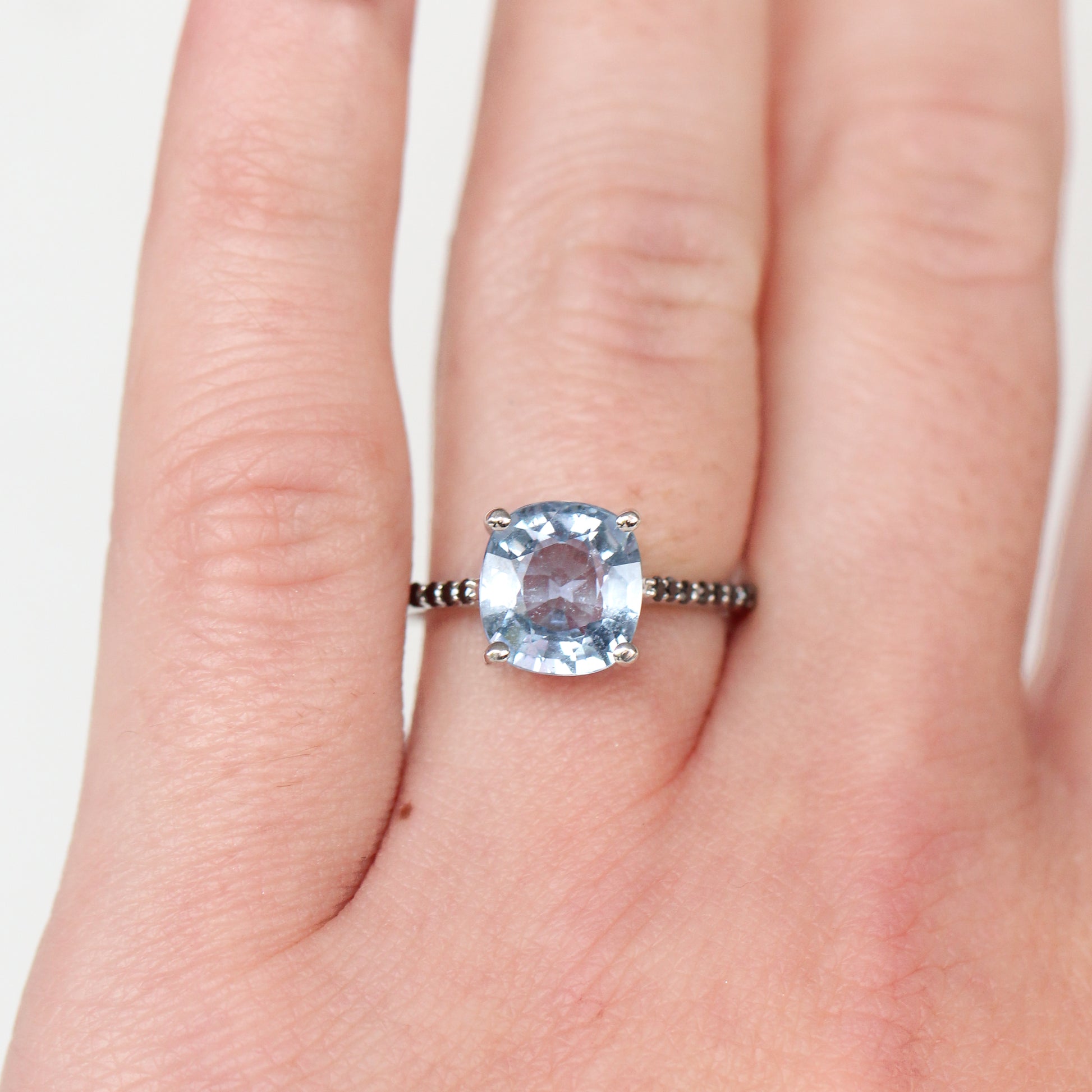 Raine Ring with a 3.18 Carat Light Blue Cushion Cut Sapphire and Black Accent Diamonds in 14k White Gold - Ready to Size and Ship - Midwinter Co. Alternative Bridal Rings and Modern Fine Jewelry