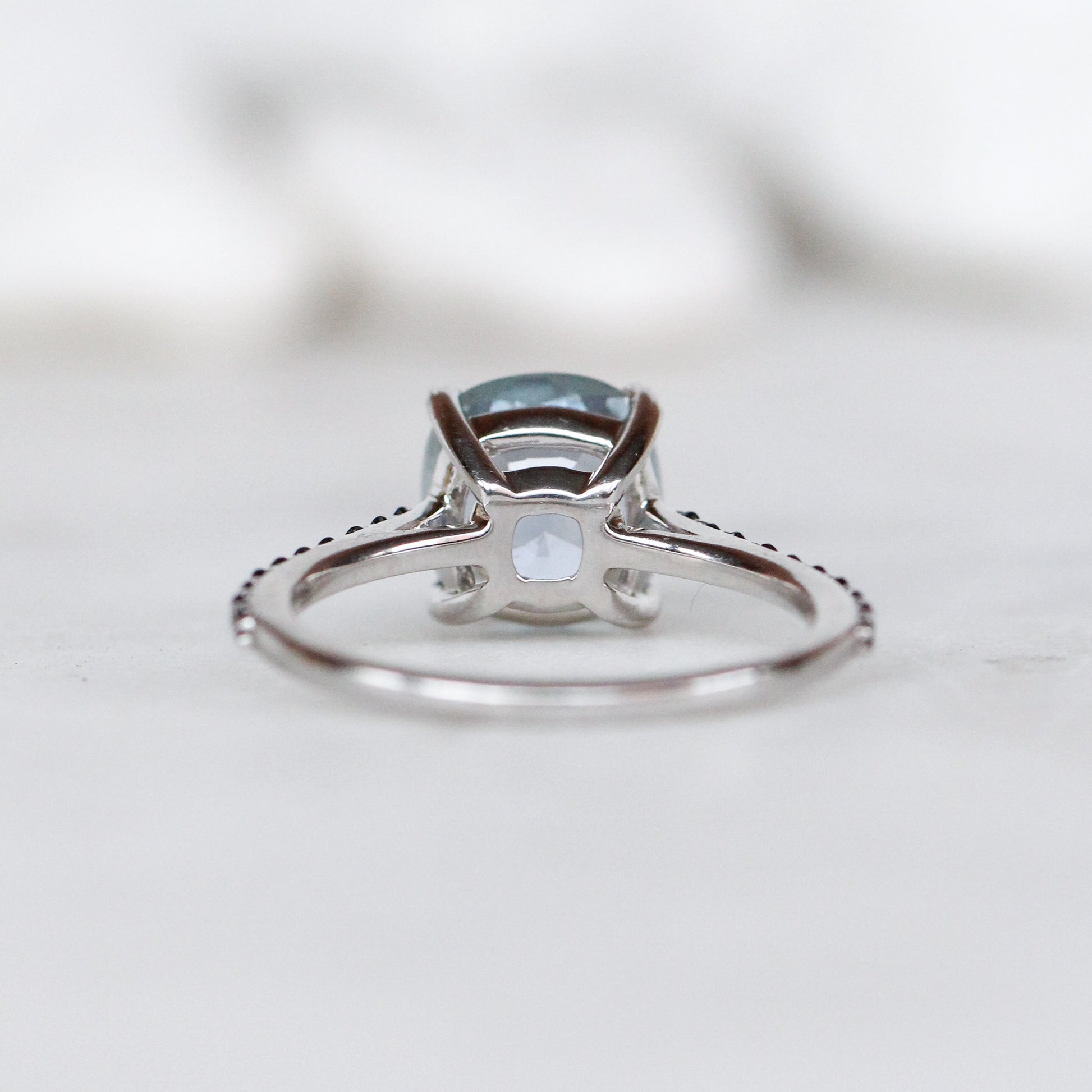 Raine Ring with a 3.18 Carat Light Blue Cushion Cut Sapphire and Black Accent Diamonds in 14k White Gold - Ready to Size and Ship - Midwinter Co. Alternative Bridal Rings and Modern Fine Jewelry