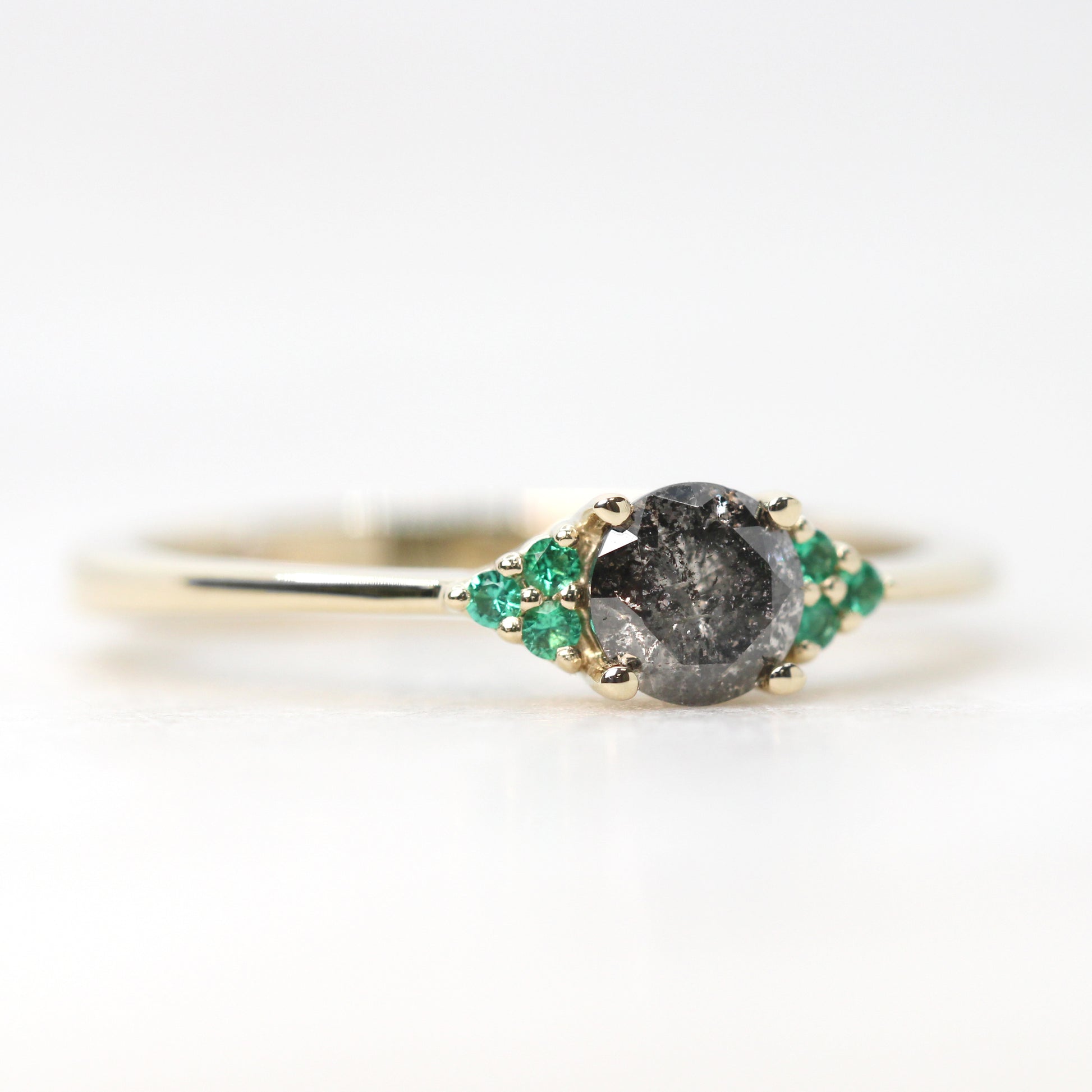 Imogene Ring with a 0.46 Carat Round Dark Gray Celestial Diamond and Emerald Accents in 14k Yellow Gold - Ready to Size and Ship - Midwinter Co. Alternative Bridal Rings and Modern Fine Jewelry