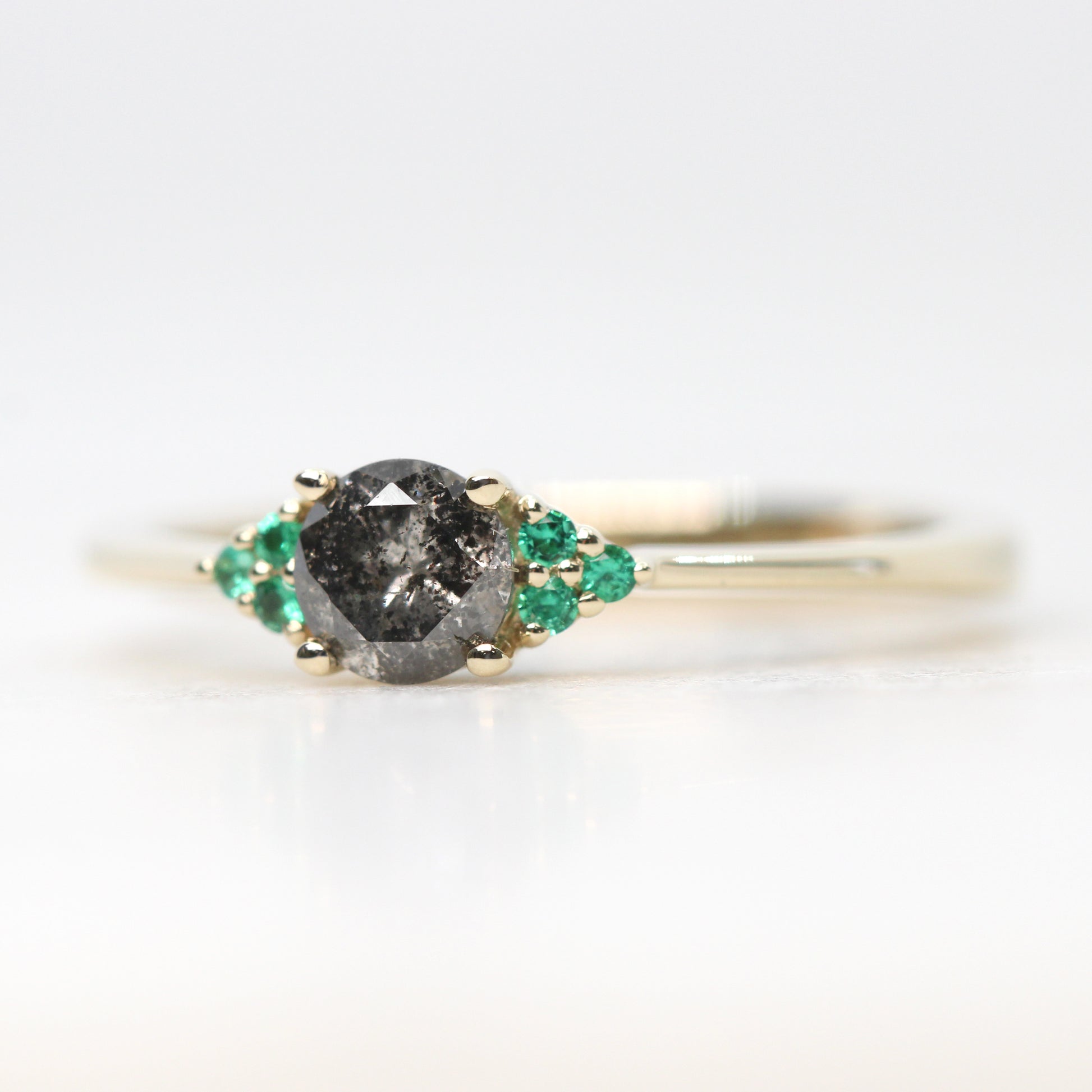 Imogene Ring with a 0.46 Carat Round Dark Gray Celestial Diamond and Emerald Accents in 14k Yellow Gold - Ready to Size and Ship - Midwinter Co. Alternative Bridal Rings and Modern Fine Jewelry